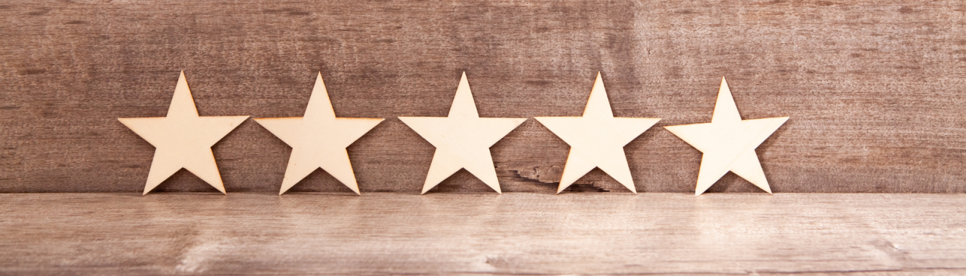 5 gold starts with wooden background