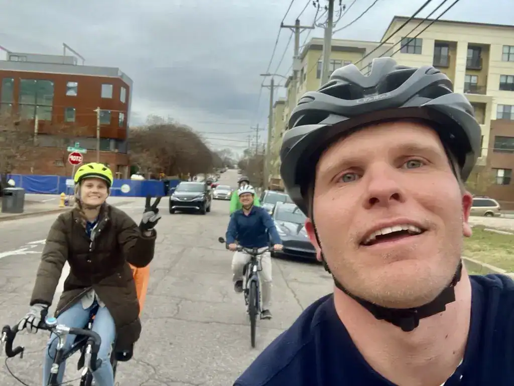 People riding bikes on a city street.