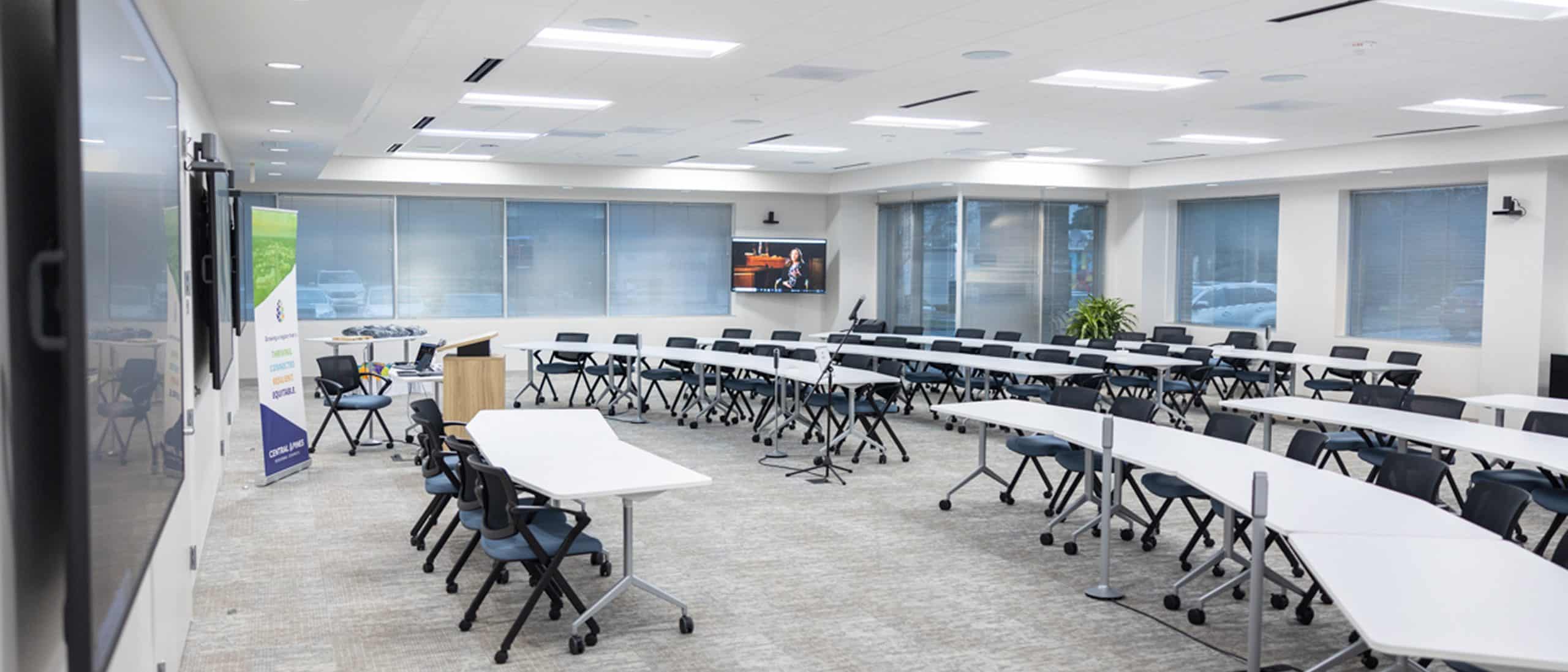 Empty conference room filled with tables and chairs.