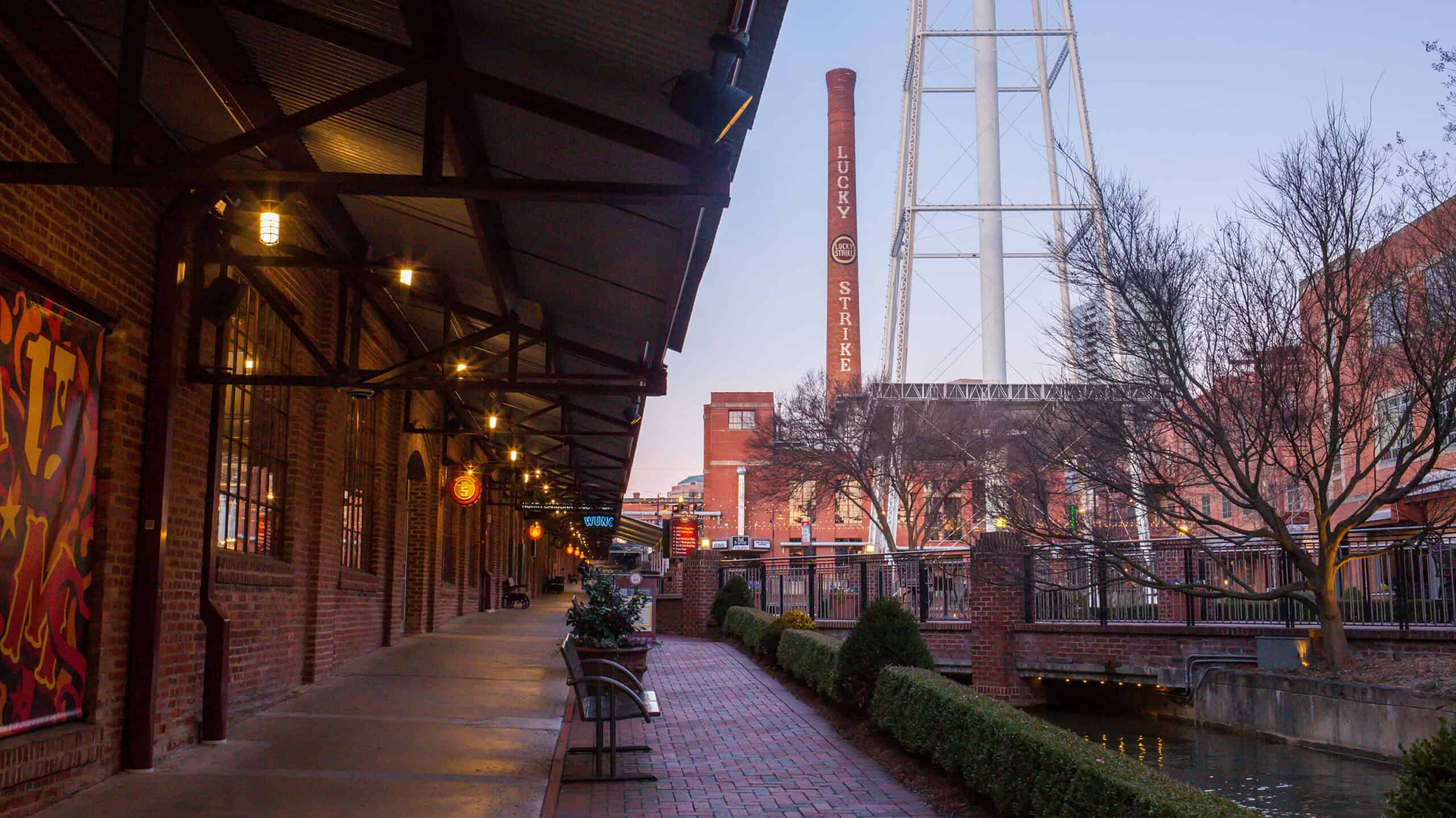 View of a courtyard area with smoke stake from factory in the background.