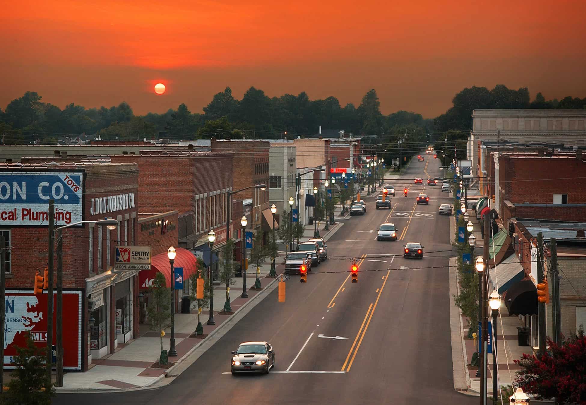 Aerial view of a downtown street at sunset.